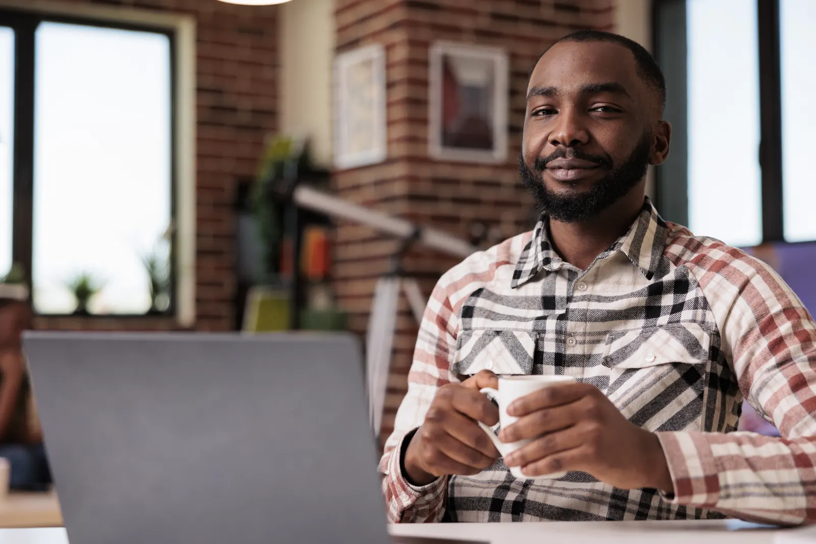 A business owner smiling at his desk
